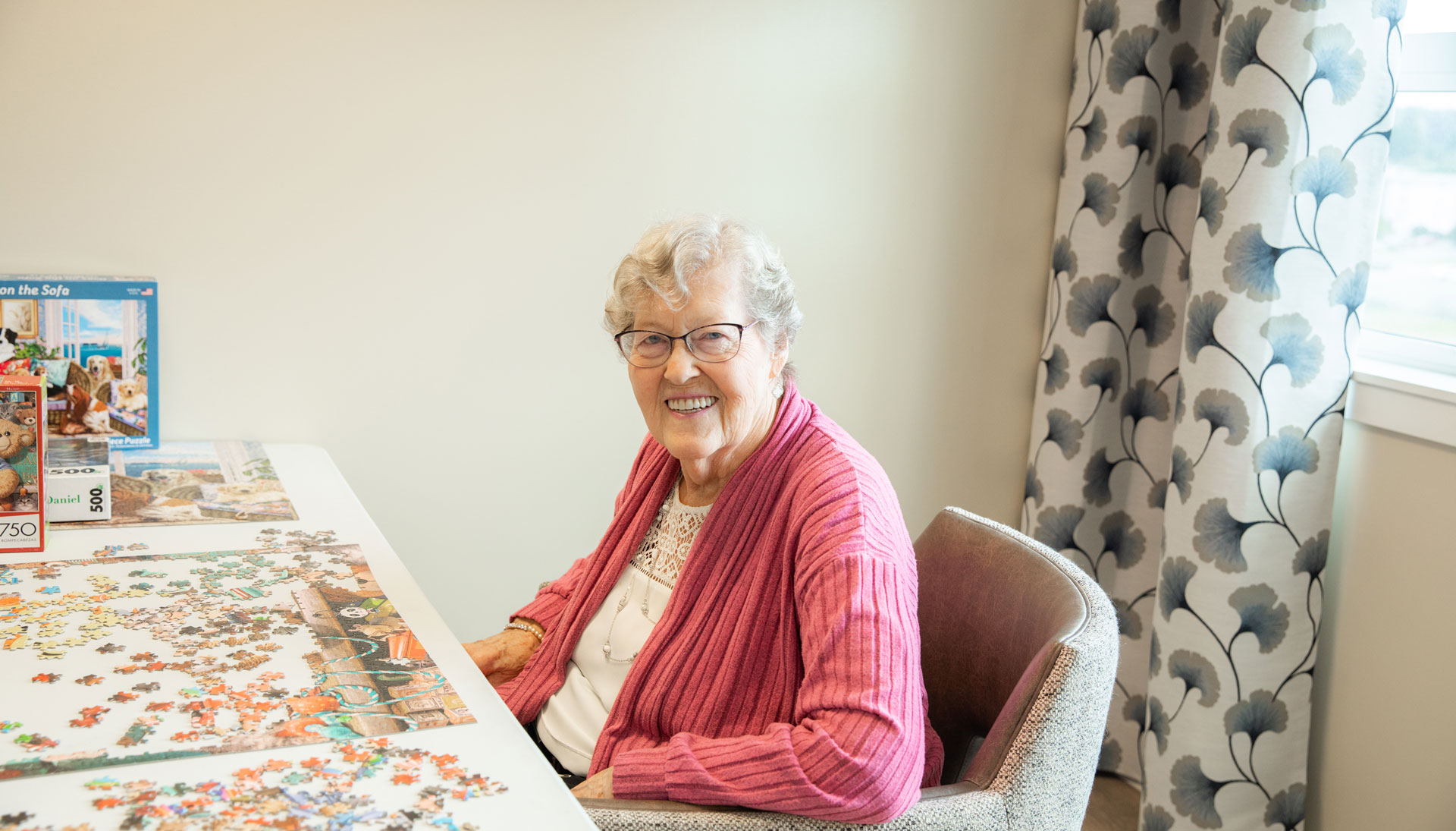 smiling resident doing puzzle